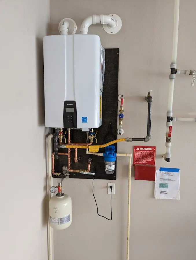 Professional plumber installing copper piping in a Norristown home